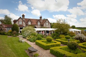 a cottage with one of our marquees in the large front garden